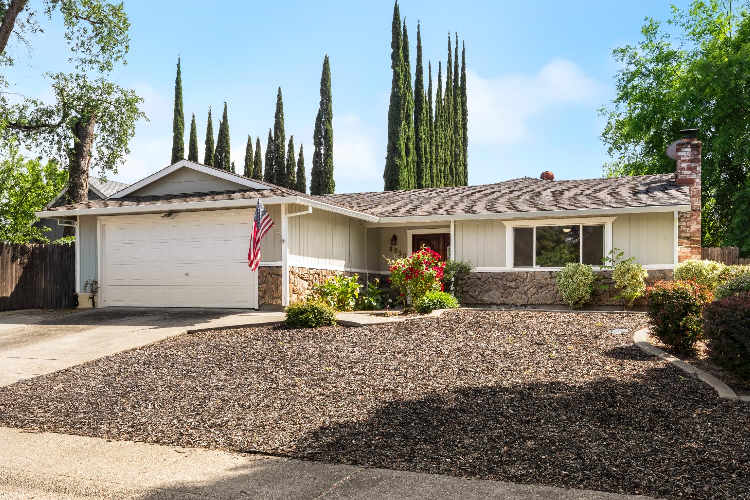 8930 Genoa Avenue Orangevale, CA 95662 - Photo 2 of 46 a front view of a house with a garden and pathway