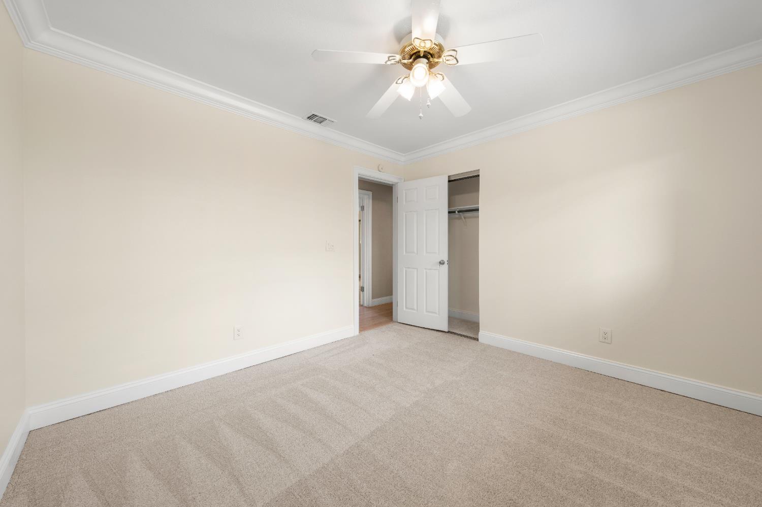 8930 Genoa Avenue Orangevale, CA 95662 - Photo 21 of 46 an empty room with a ceiling fan and a window