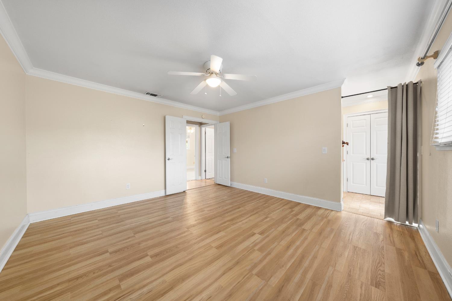 8930 Genoa Avenue Orangevale, CA 95662 - Photo 26 of 46 a view of an empty room with wooden floor and a ceiling fan