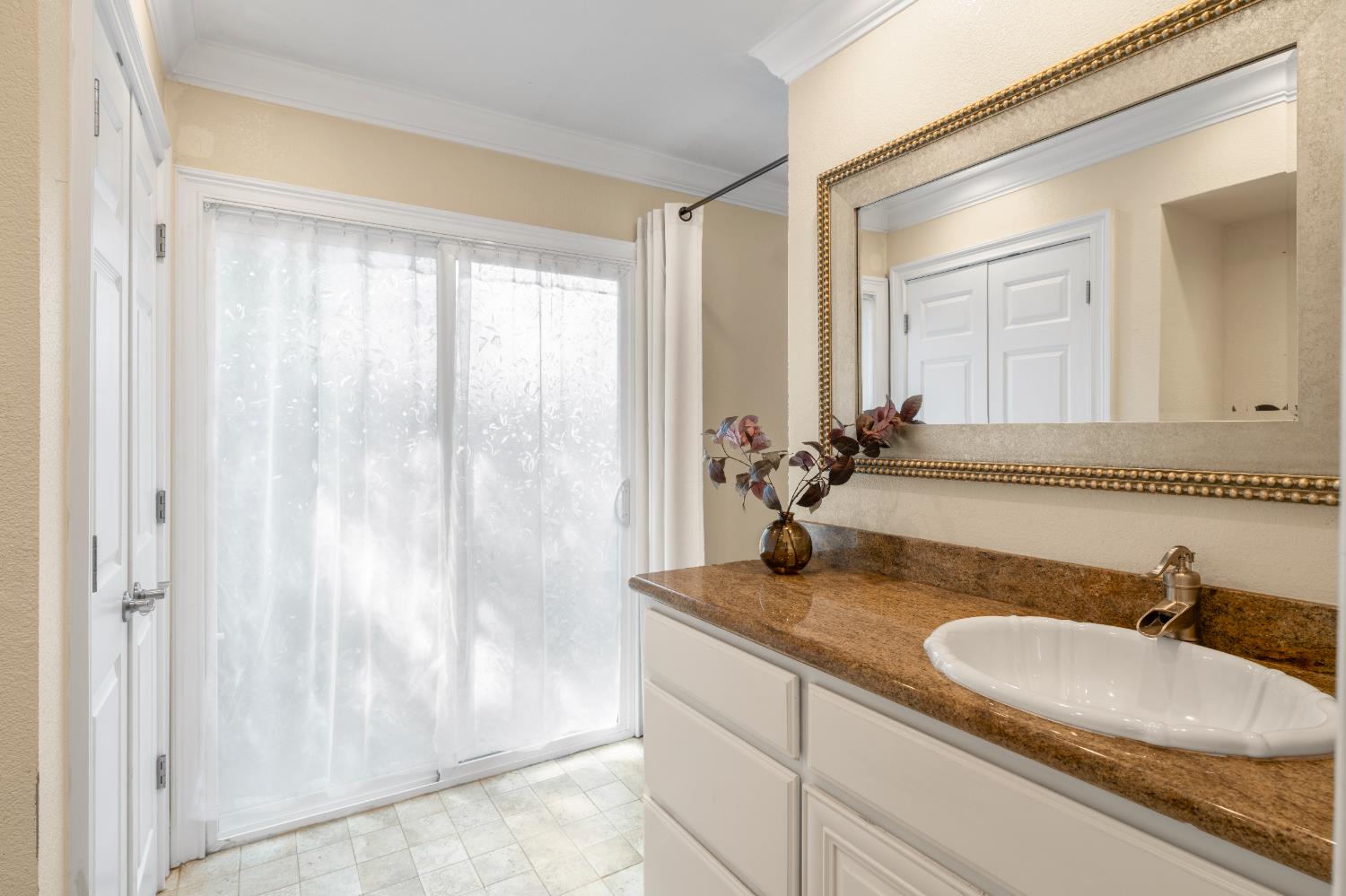 8930 Genoa Avenue Orangevale, CA 95662 - Photo 29 of 46 a bathroom with a granite countertop sink and a mirror