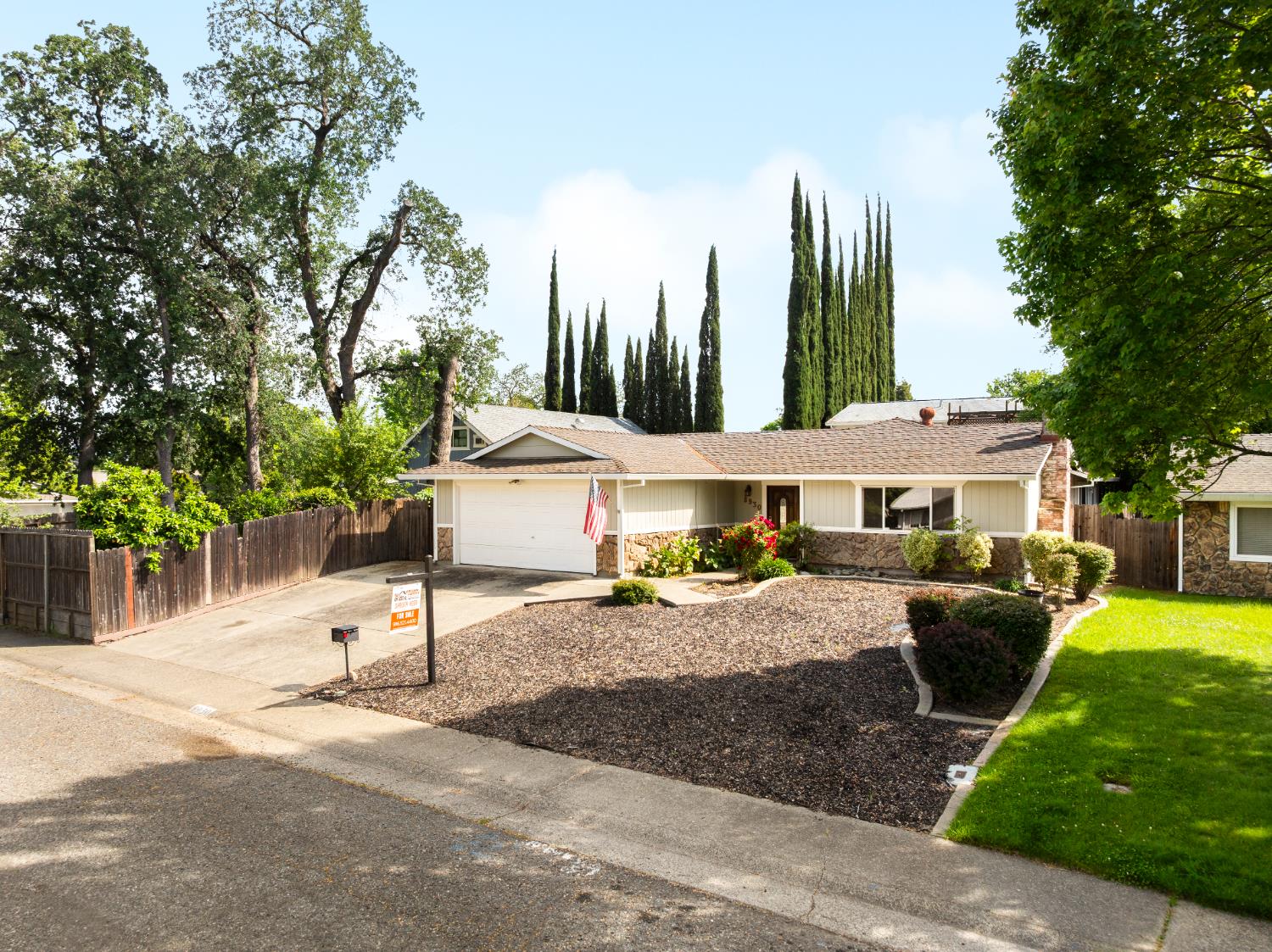 8930 Genoa Avenue Orangevale, CA 95662 - Photo 36 of 46 a view of a patio with a table and chairs under an umbrella with a fire pit