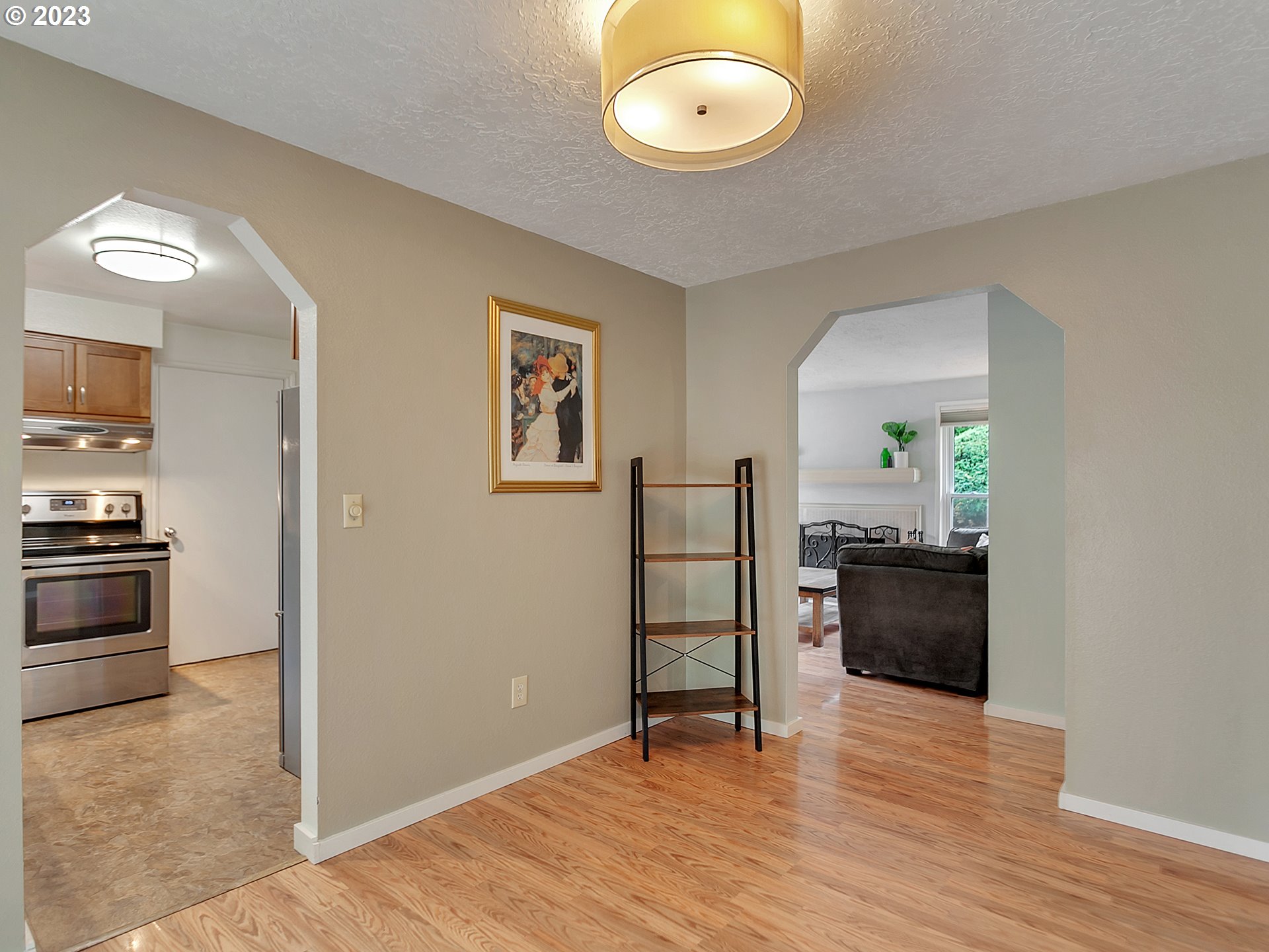 5715 Southwest Pendleton Street Portland, OR 97221 - Photo 11 of 31 a view of a kitchen and an empty room with wooden floor