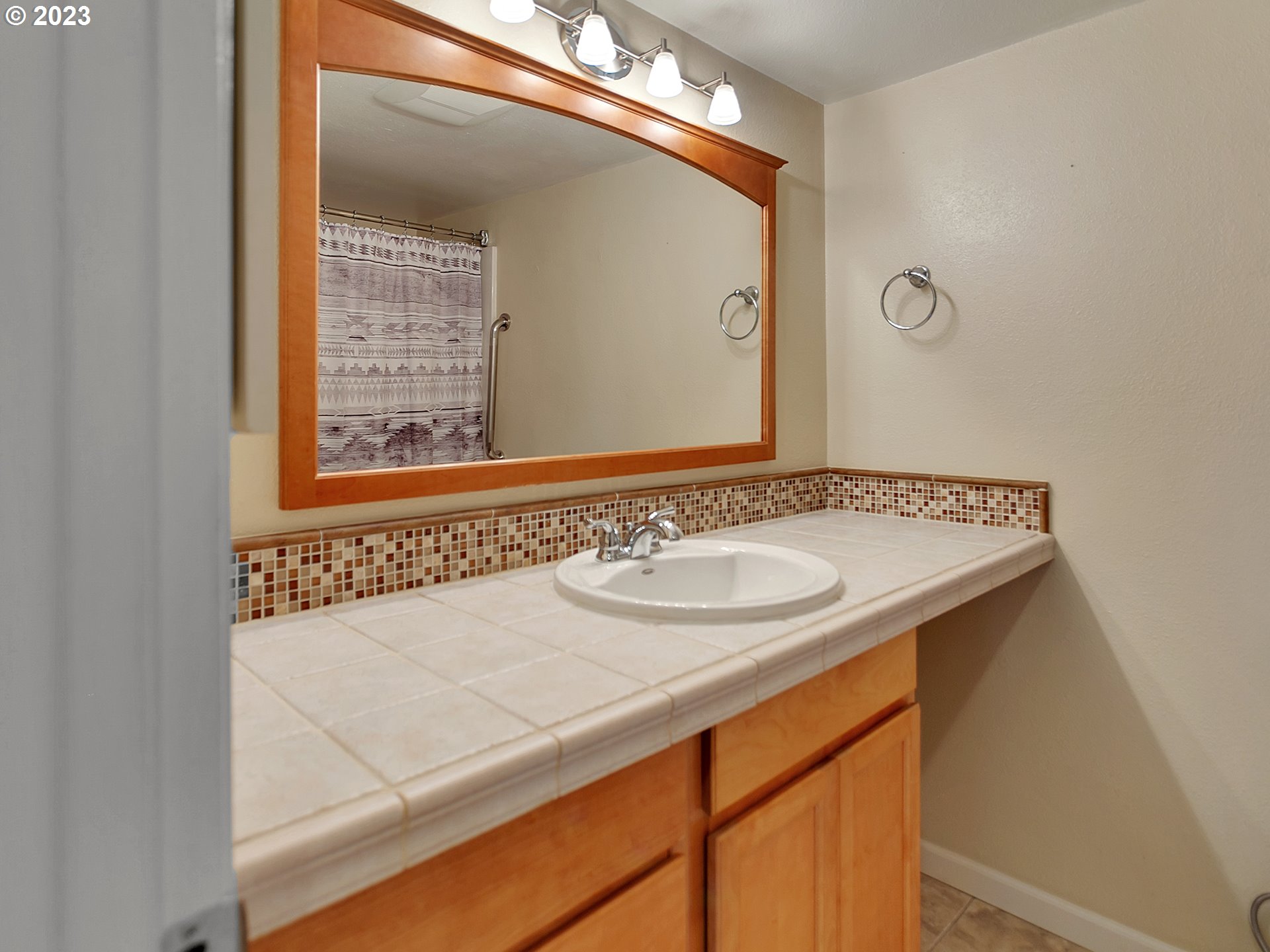 5715 Southwest Pendleton Street Portland, OR 97221 - Photo 13 of 31 a bathroom with a sink and a mirror