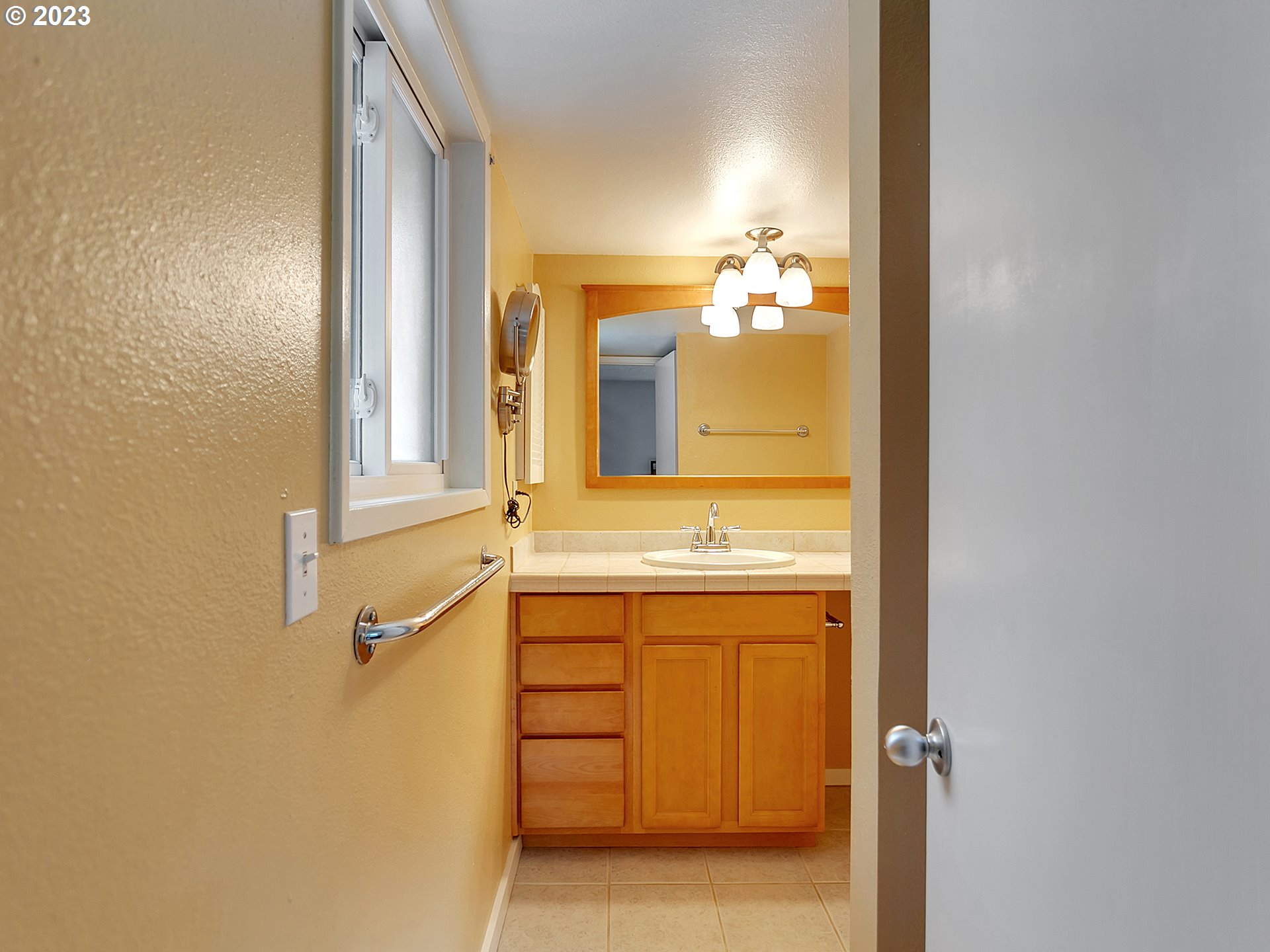 5715 Southwest Pendleton Street Portland, OR 97221 - Photo 15 of 31 a bathroom with a sink and a mirror