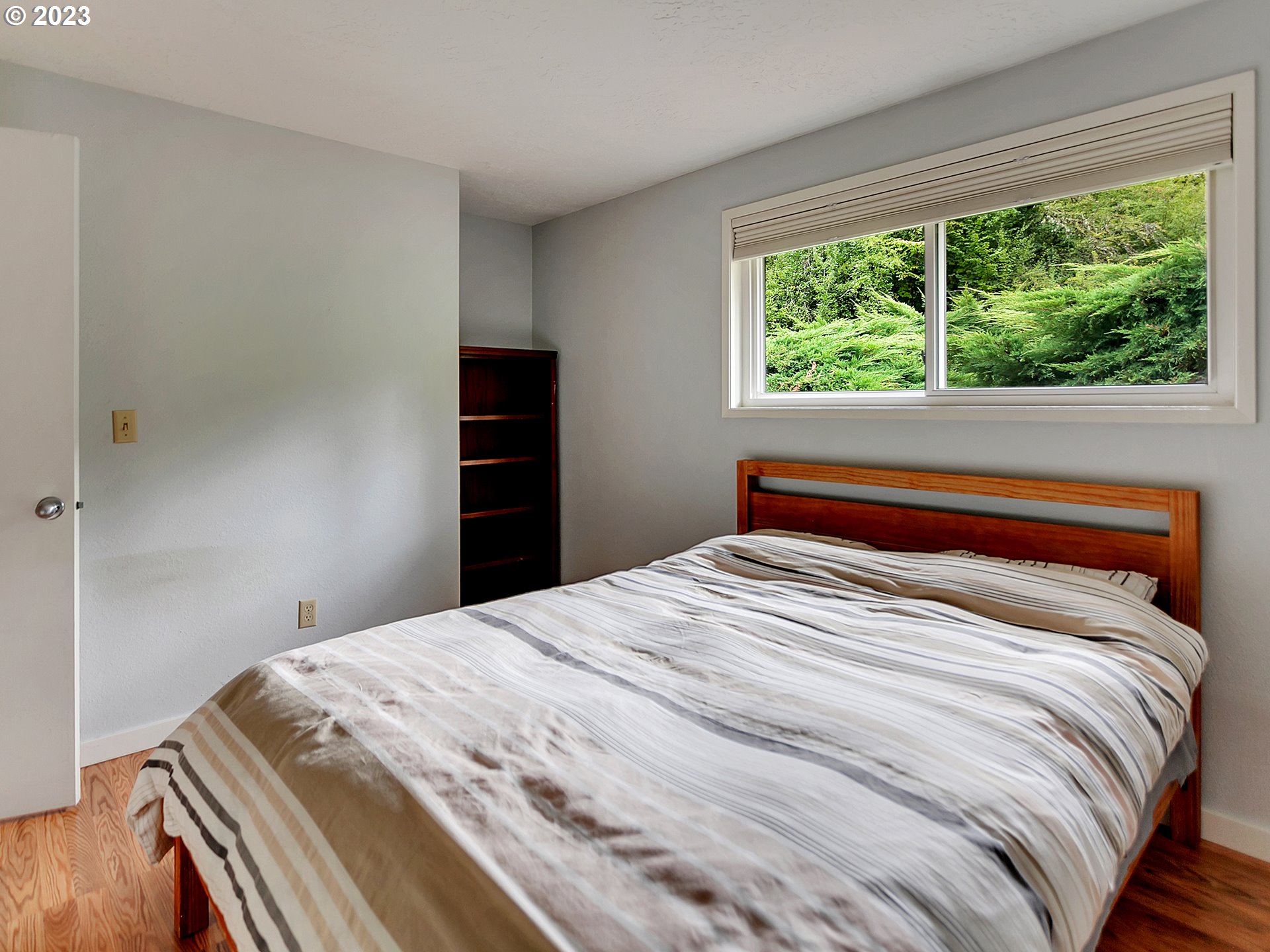 5715 Southwest Pendleton Street Portland, OR 97221 - Photo 17 of 31 a bedroom with a bed and a window
