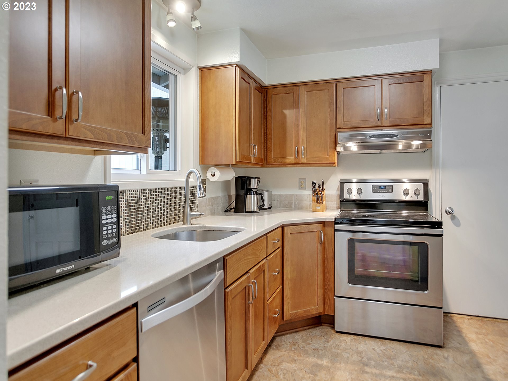 5715 Southwest Pendleton Street Portland, OR 97221 - Photo 6 of 31 a kitchen with granite countertop a stove sink and cabinets
