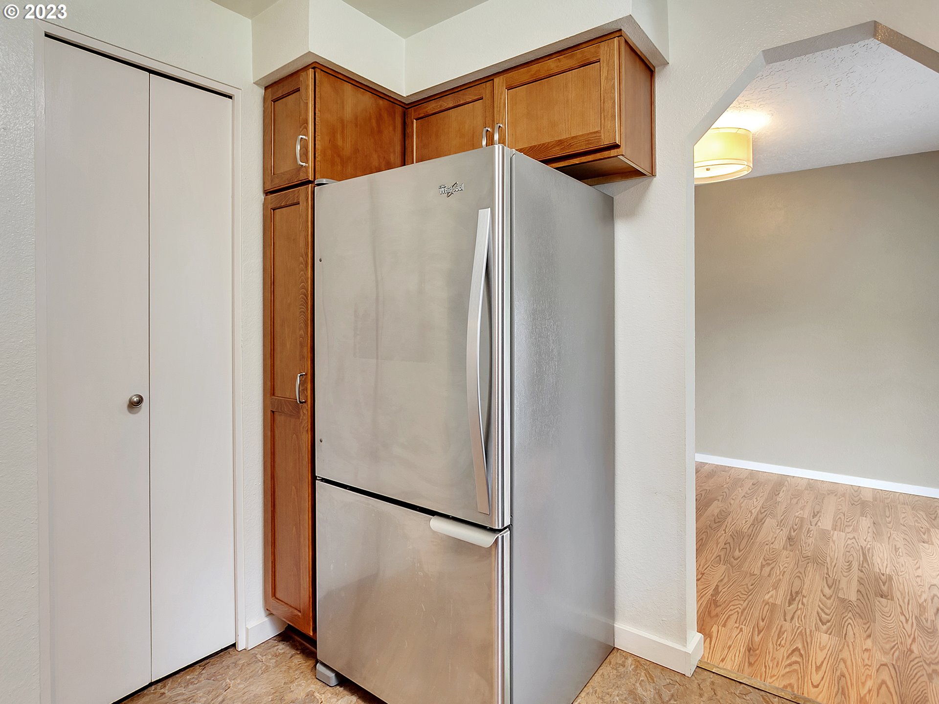 5715 Southwest Pendleton Street Portland, OR 97221 - Photo 10 of 31 a white refrigerator freezer and a microwave in a kitchen