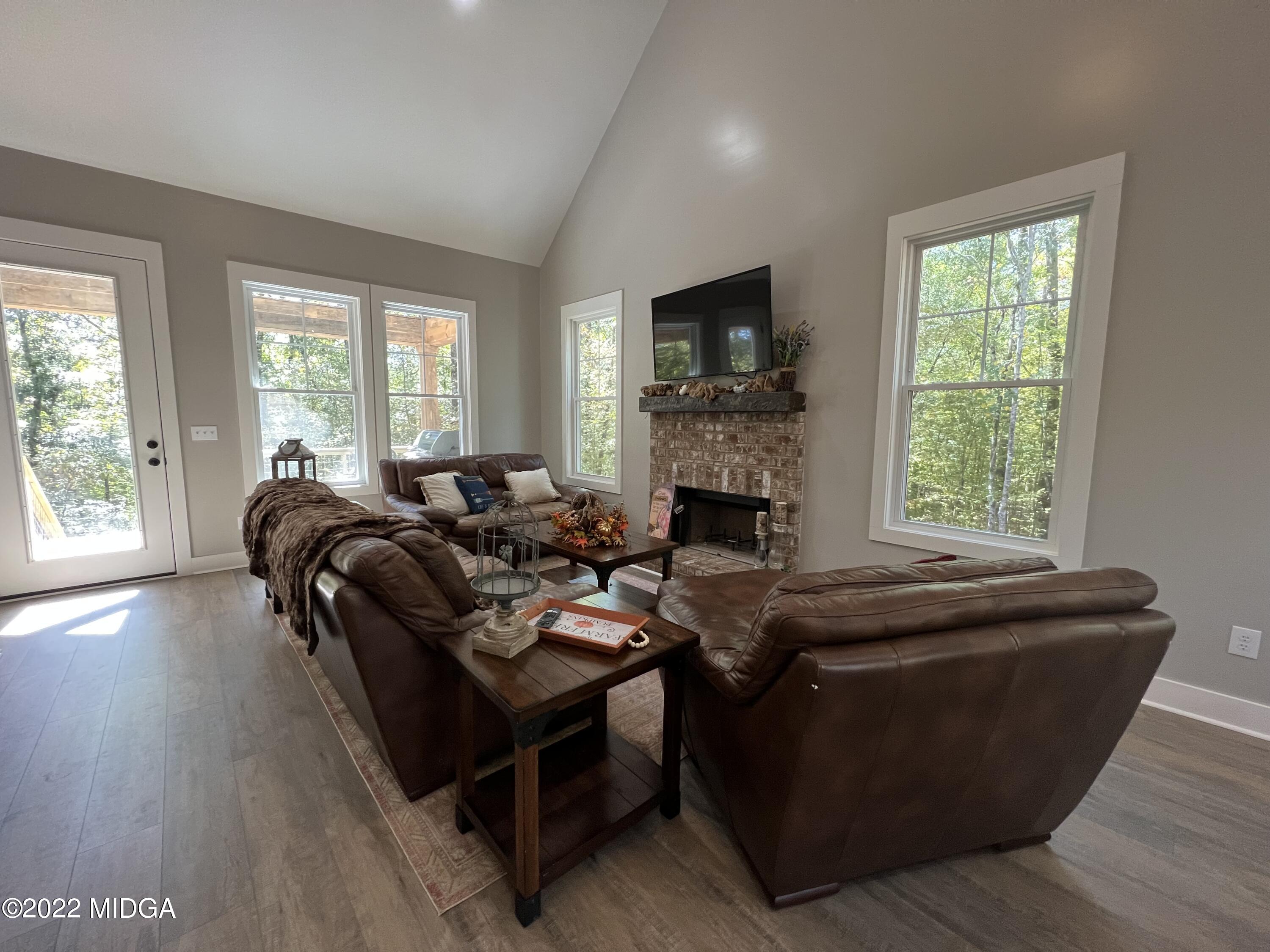 142 Towaliga Road Forsyth, GA 31029 - Photo 8 of 21 a living room with furniture and a fireplace