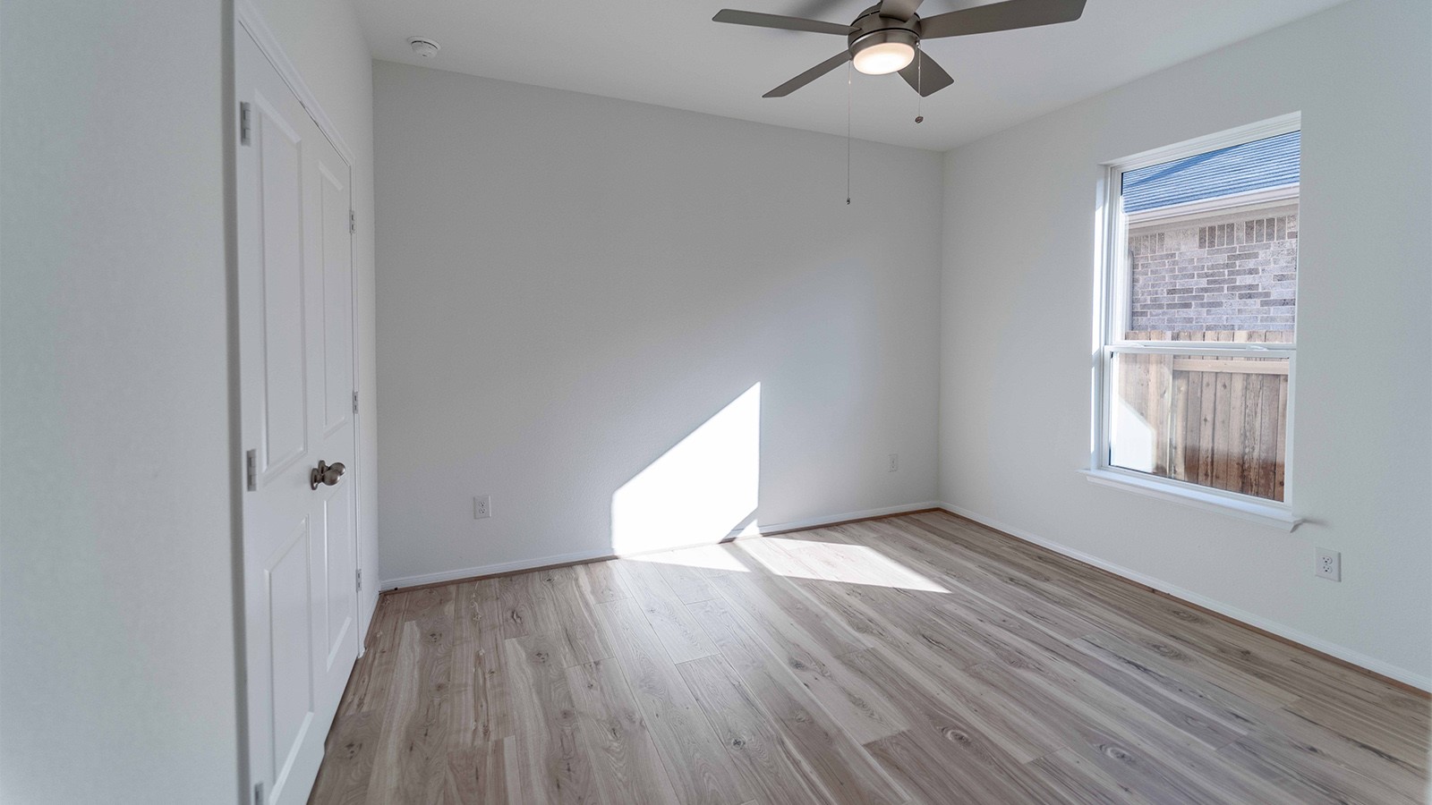 294 Rubber Tree Way Buda, TX 78610 - Photo 7 of 19 Unfurnished bedroom with light wood-type flooring, a ceiling fan, and a closet