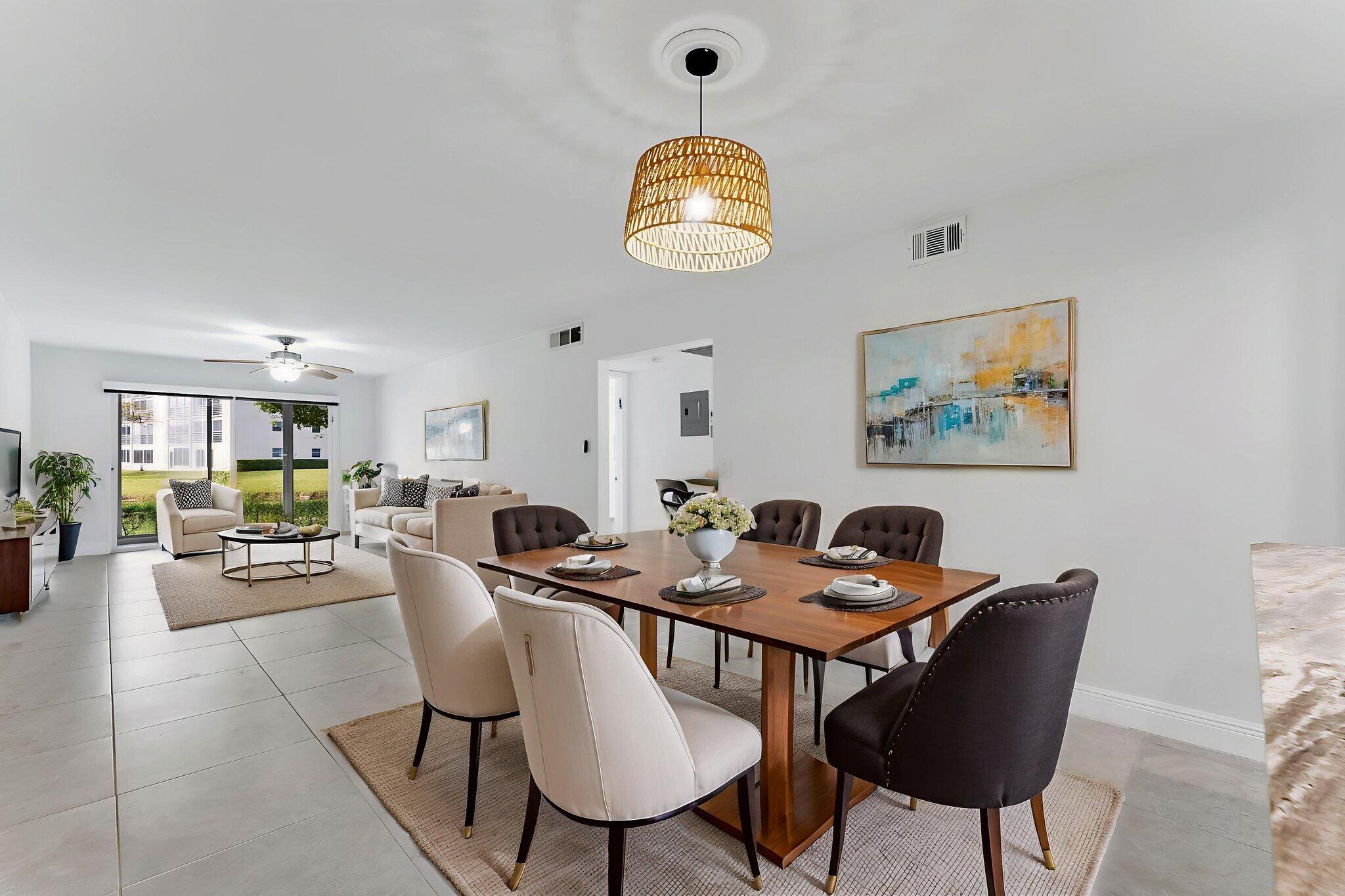 1037 Guilford C Boca Raton, FL 33434 - Photo 11 of 35 a view of a dining room with furniture and chandelier