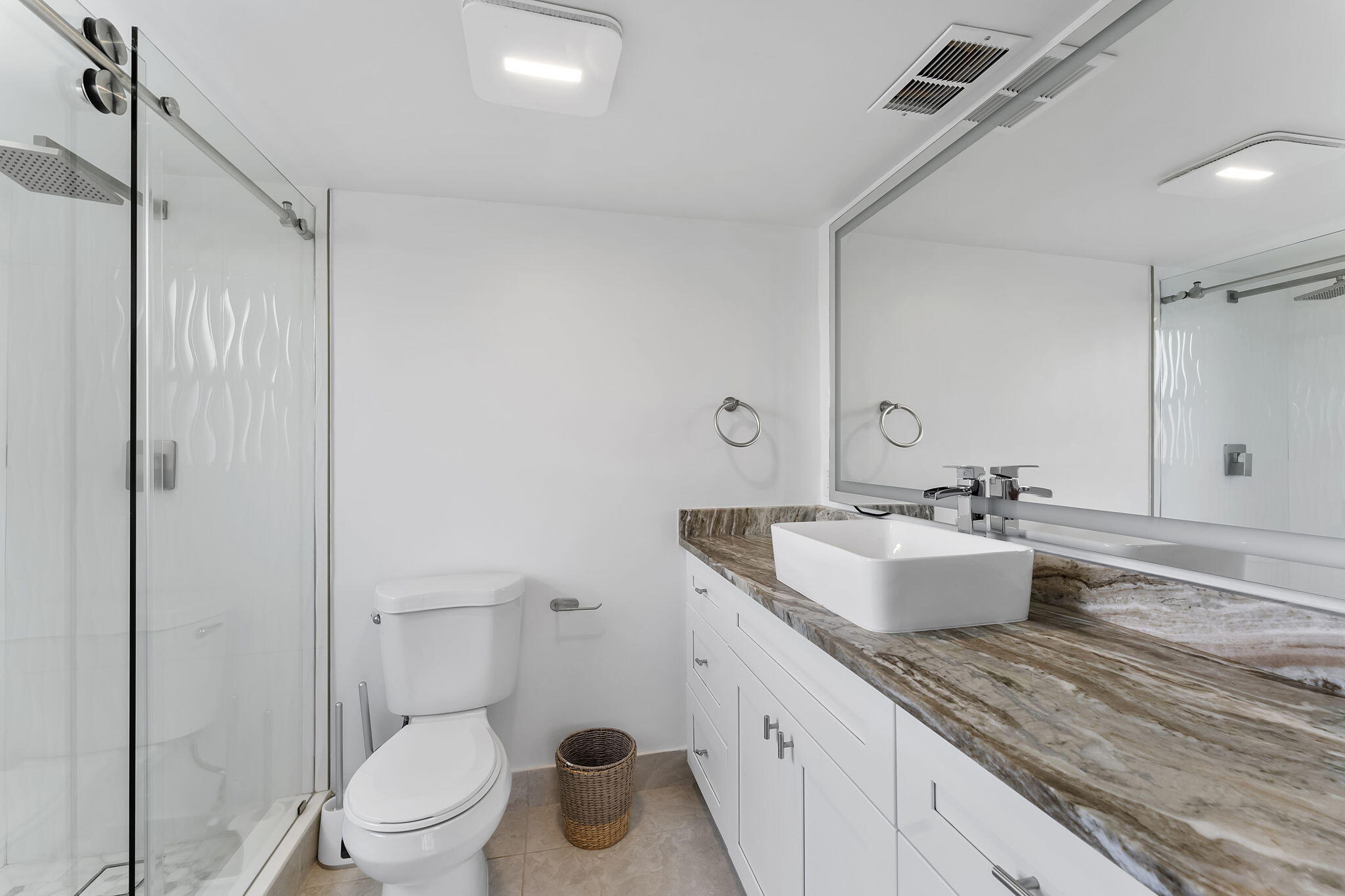 1037 Guilford C Boca Raton, FL 33434 - Photo 16 of 35 a bathroom with a granite countertop sink mirror vanity and toilet