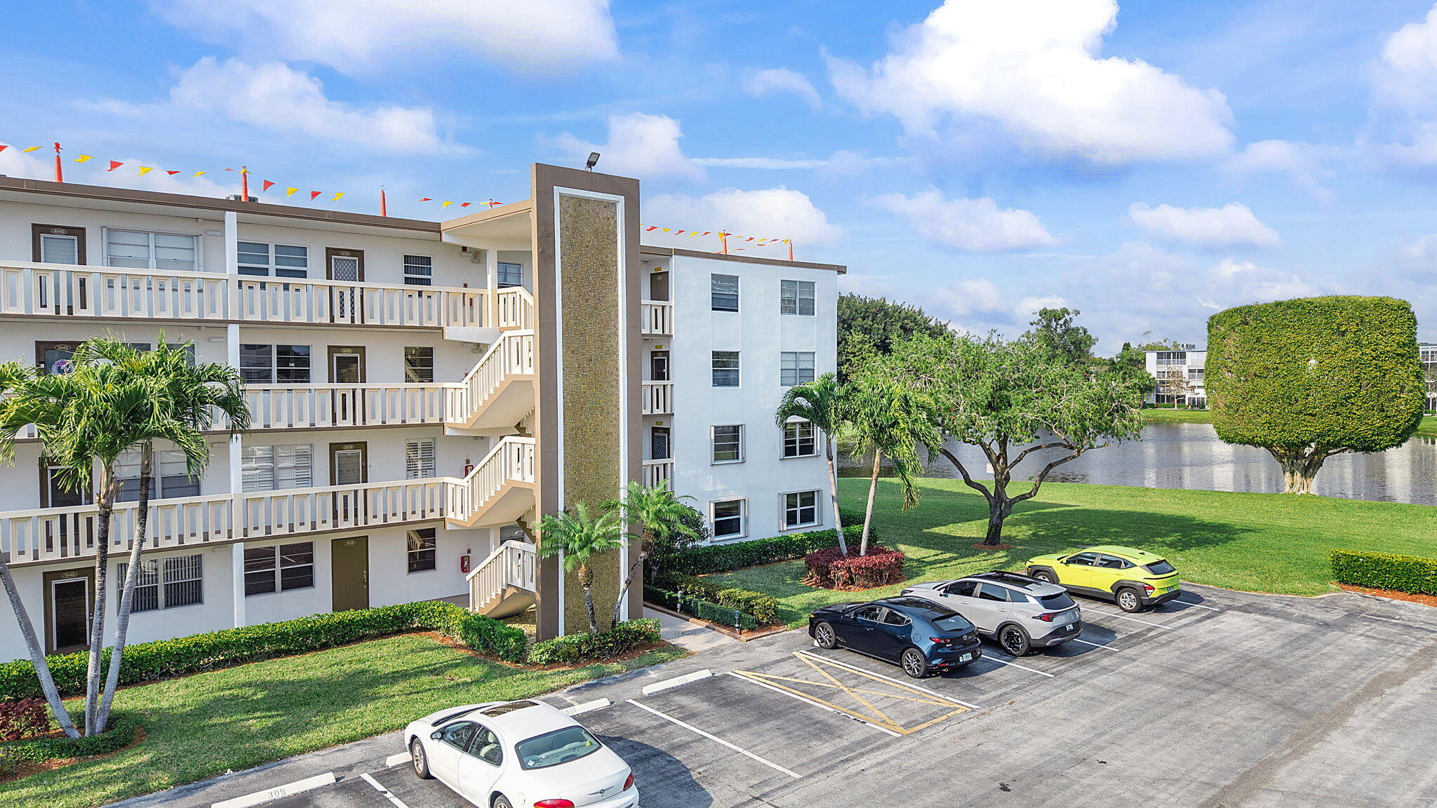 1037 Guilford C Boca Raton, FL 33434 - Photo 18 of 35 a street view with tall buildings and a yard