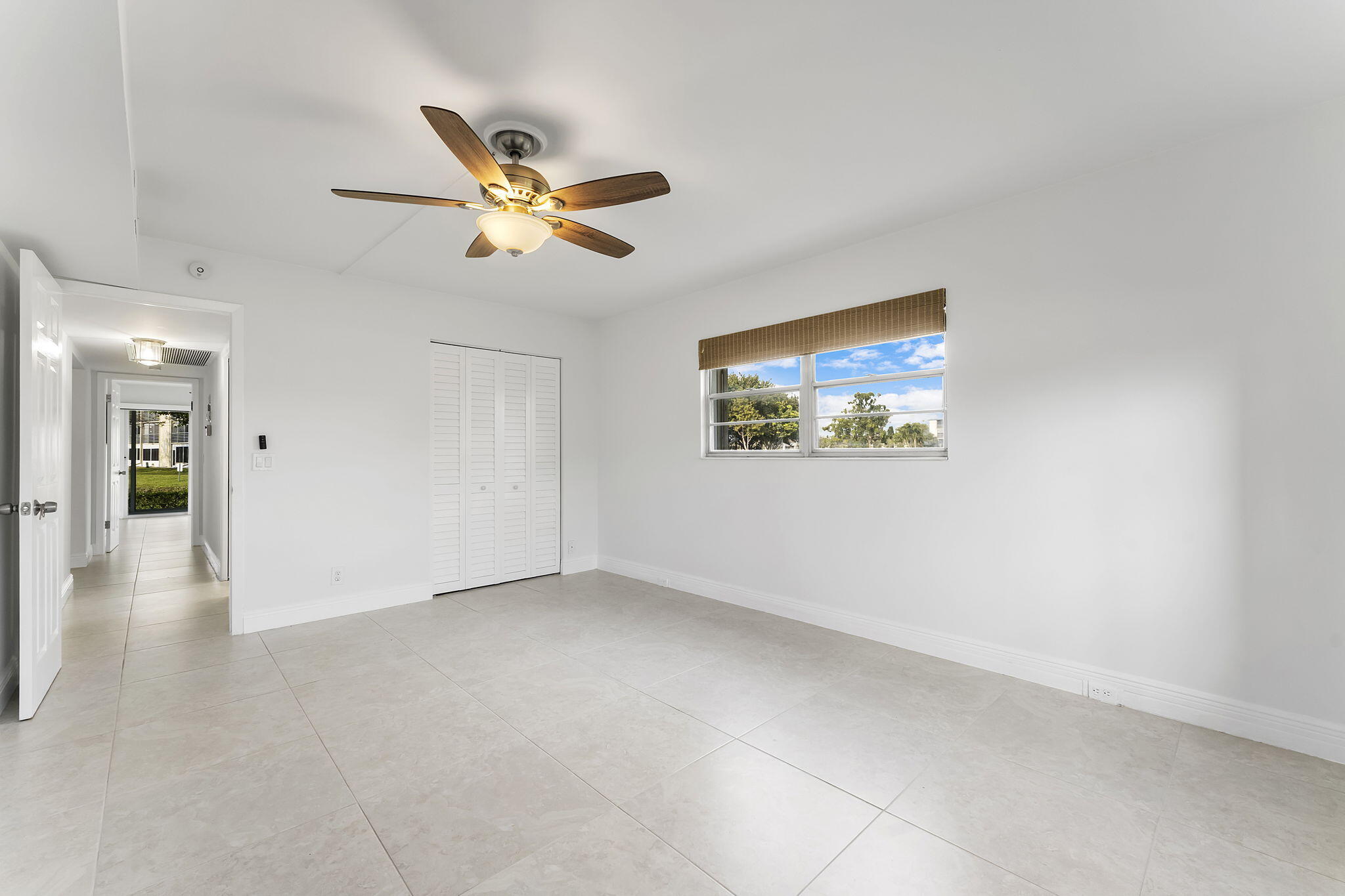 1037 Guilford C Boca Raton, FL 33434 - Photo 20 of 35 a view of a livingroom with a ceiling fan and window