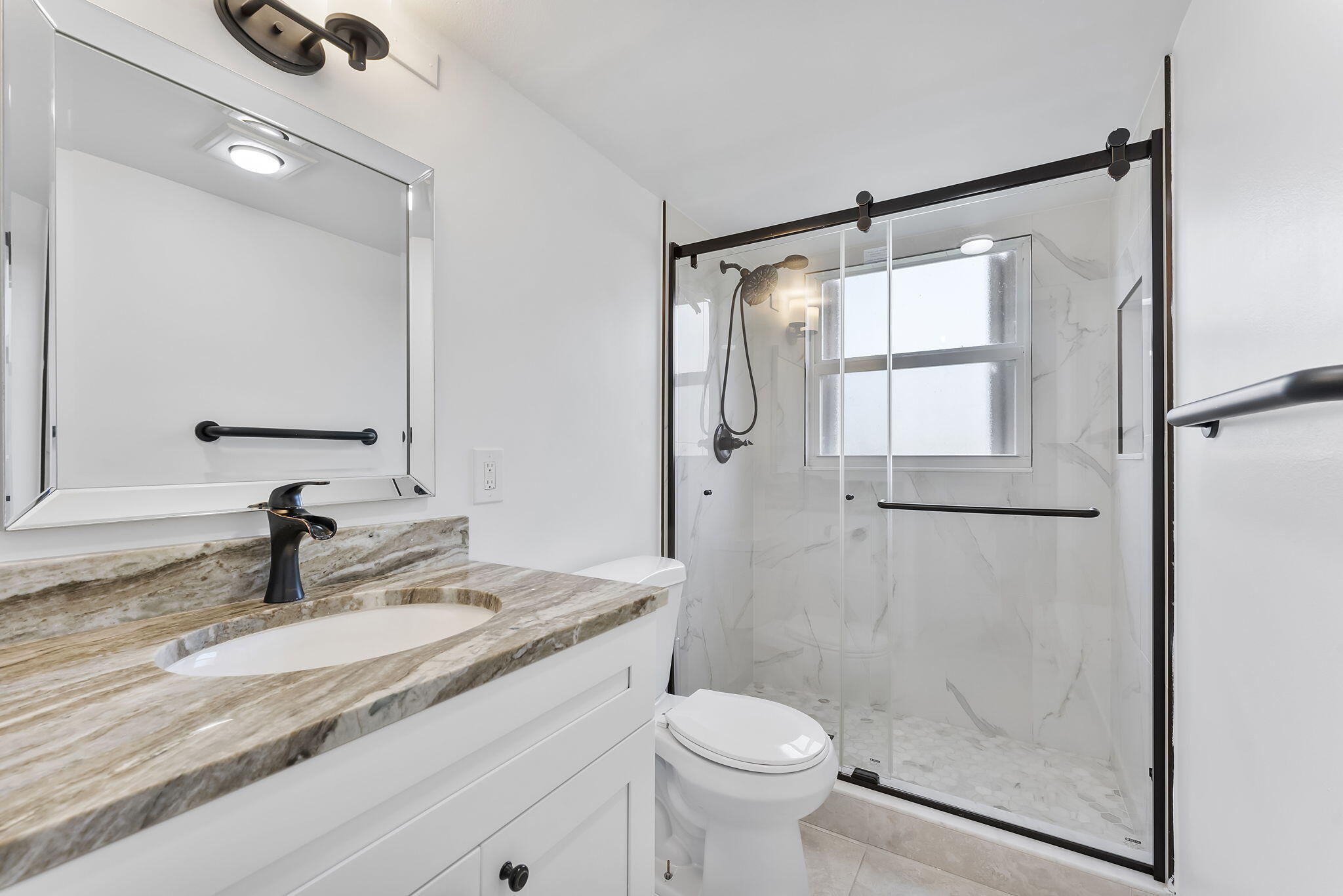 1037 Guilford C Boca Raton, FL 33434 - Photo 22 of 35 a bathroom with a granite countertop sink toilet and shower