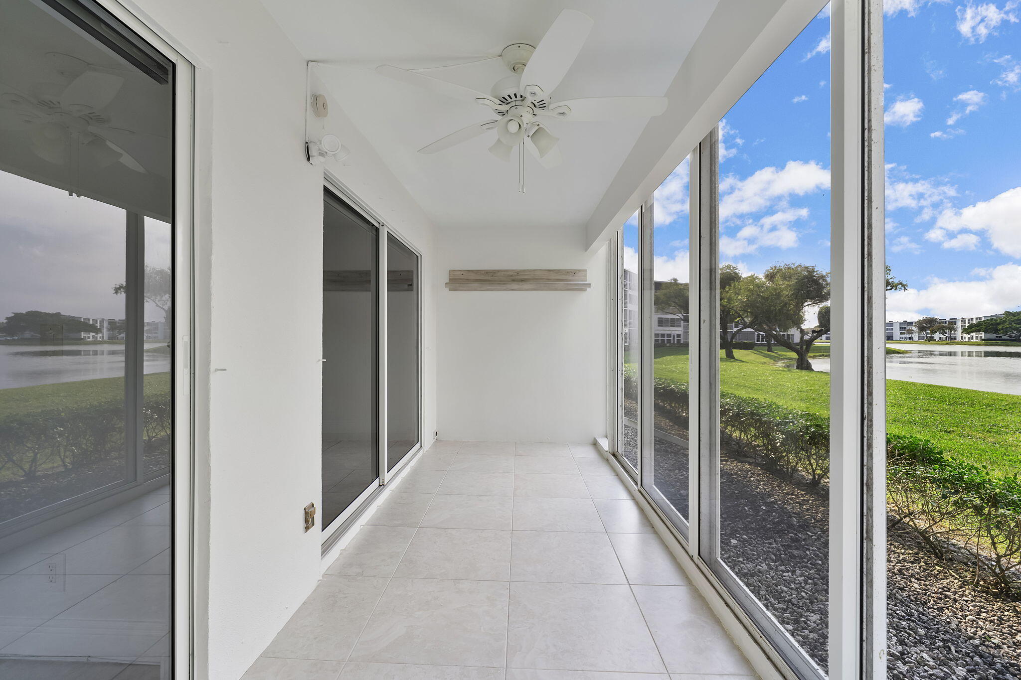 1037 Guilford C Boca Raton, FL 33434 - Photo 25 of 35 a view of a glass door and a floor to ceiling window