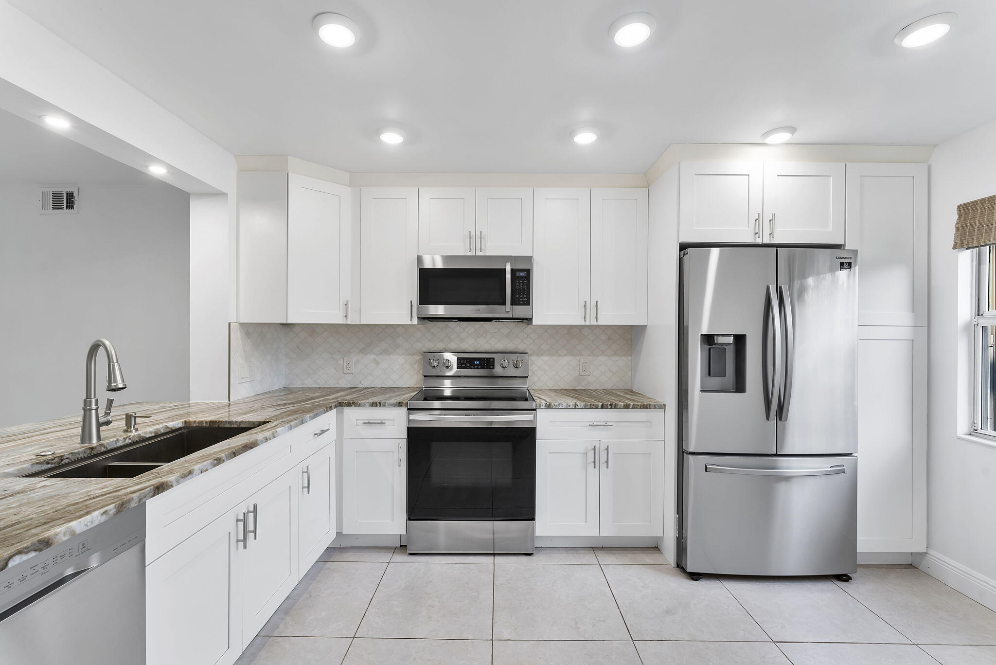 1037 Guilford C Boca Raton, FL 33434 - Photo 3 of 35 a kitchen with a refrigerator sink and microwave