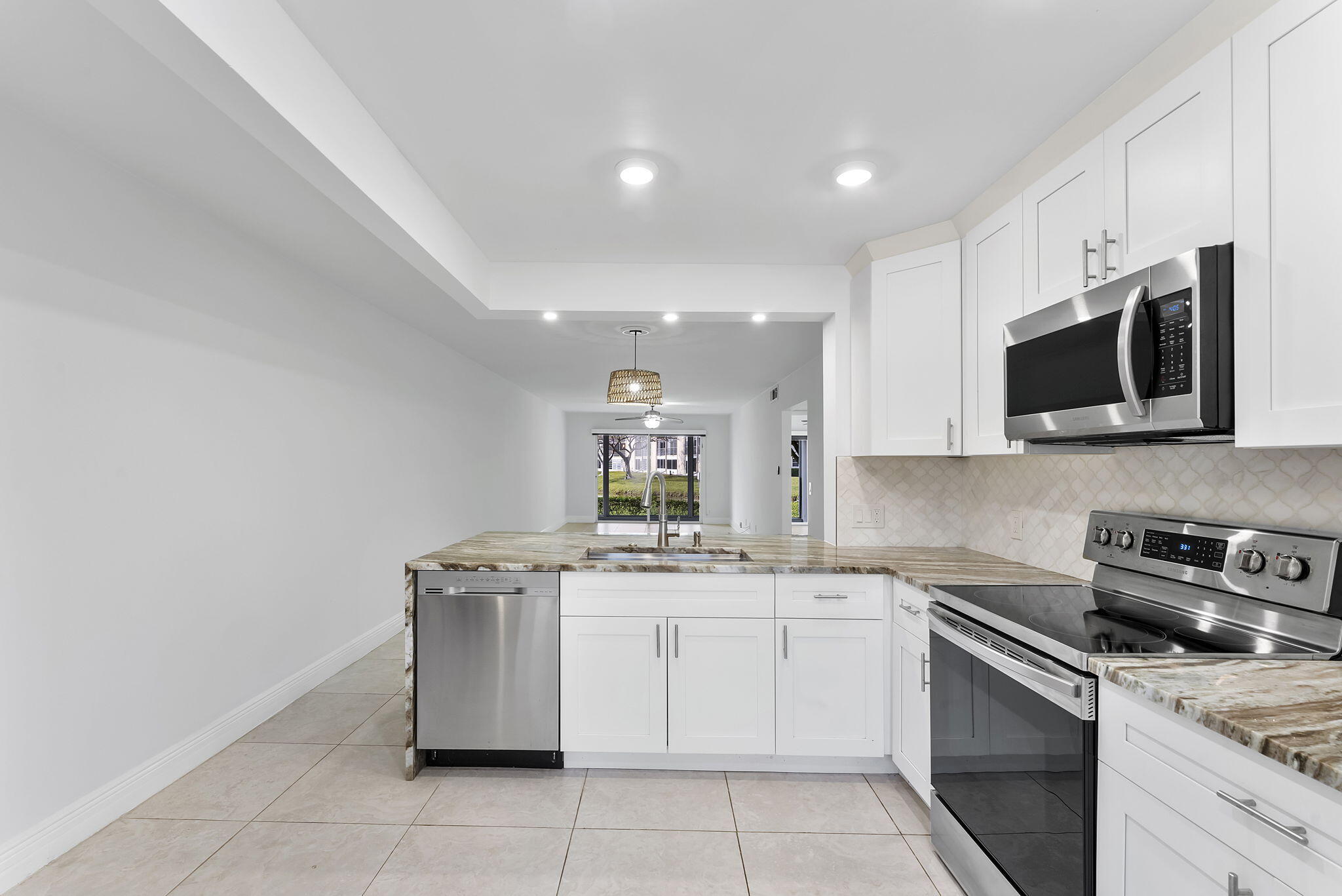 1037 Guilford C Boca Raton, FL 33434 - Photo 8 of 35 a kitchen with a sink stove and microwave