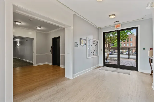 a view of an empty room with glass door and a window