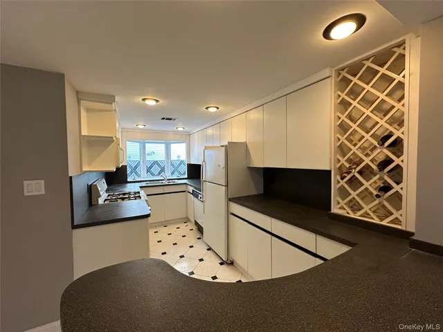 a kitchen with stainless steel appliances kitchen island granite countertop a sink and a stove