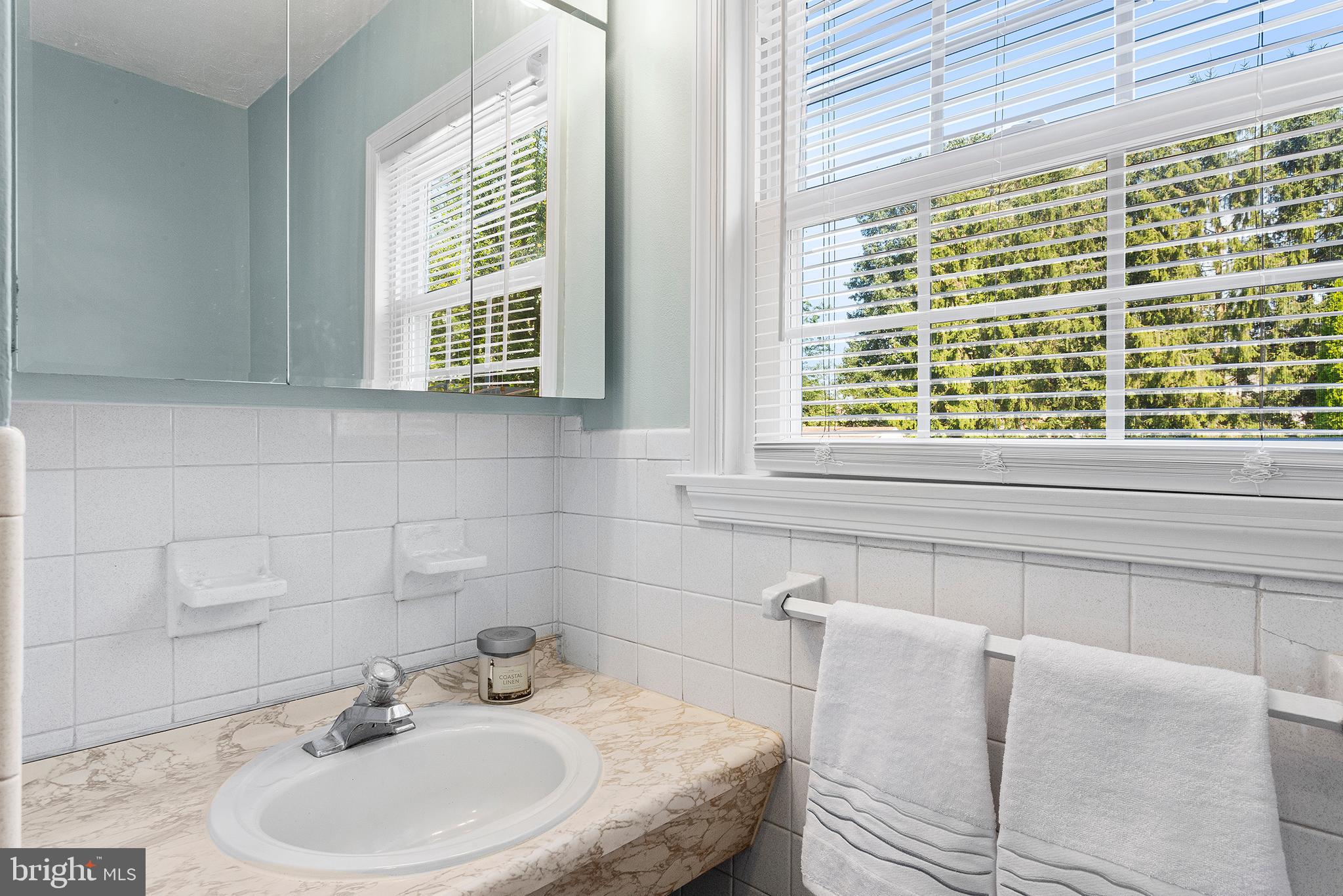 409 Franklin Road Glassboro, NJ 08028 - Photo 13 of 30 a bathroom with a sink and a window