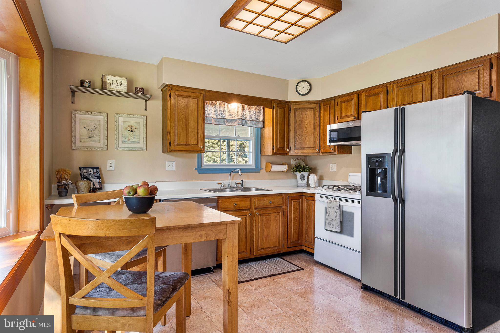 409 Franklin Road Glassboro, NJ 08028 - Photo 6 of 30 a kitchen with stainless steel appliances granite countertop a refrigerator a sink dishwasher a stove with white cabinets and wooden floor