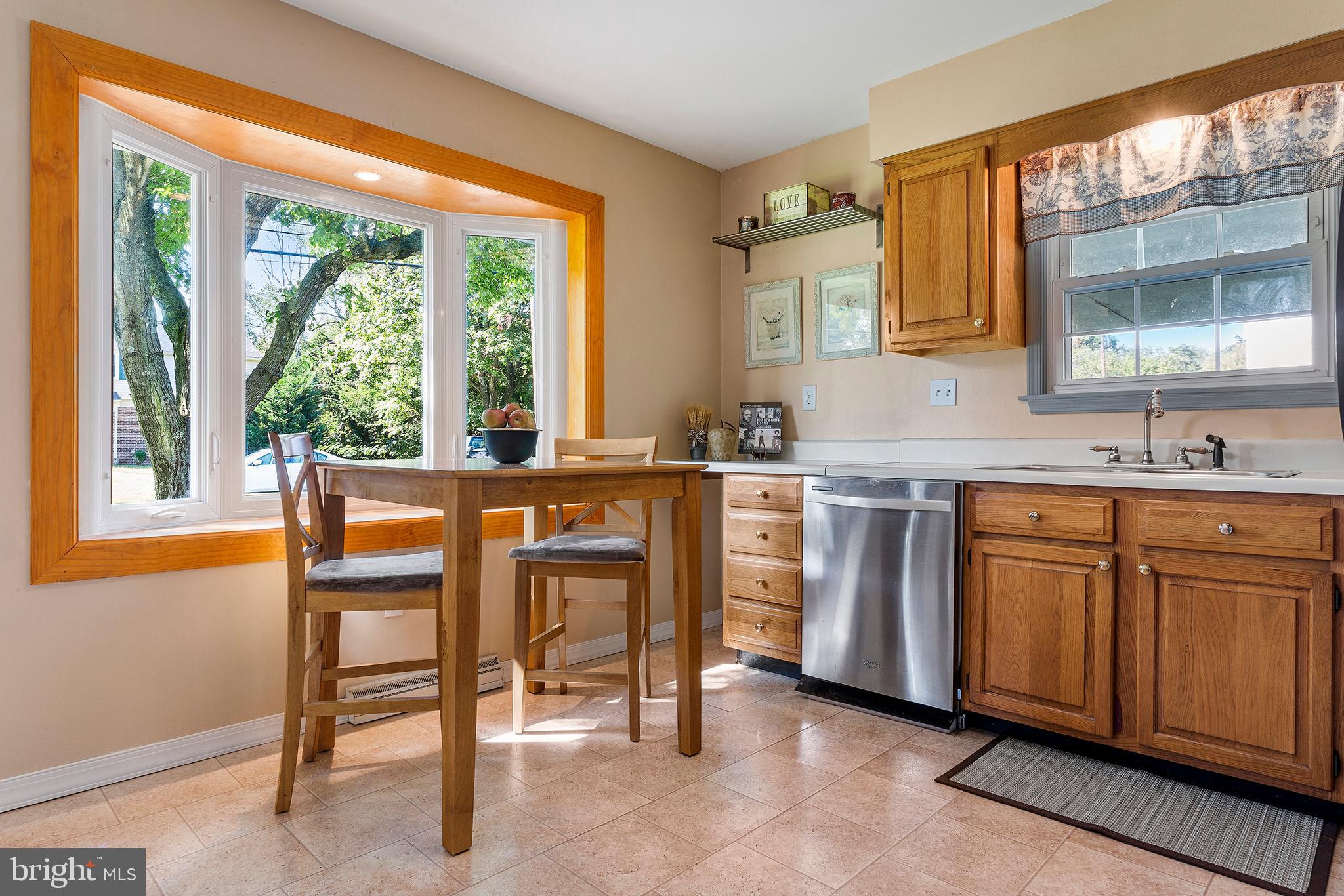409 Franklin Road Glassboro, NJ 08028 - Photo 7 of 30 a kitchen with stainless steel appliances a table and chairs in it