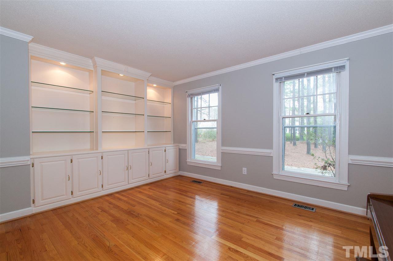 340 Sandhurst Road Raleigh, NC 27615 - Photo 14 of 25 an empty room with wooden floor and windows