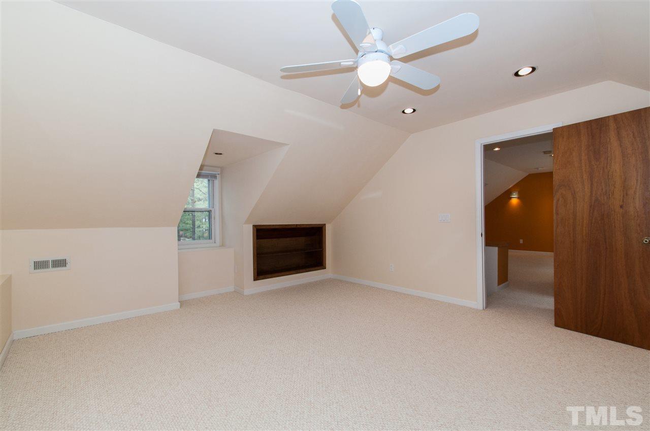 340 Sandhurst Road Raleigh, NC 27615 - Photo 22 of 25 an empty room with a ceiling fan and a window