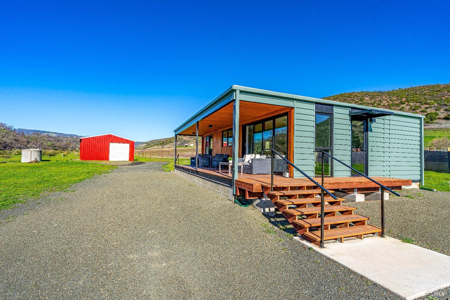 7871 Butts Canyon Road Pope Valley, CA 94567 - Photo 5 of 31 a bench is sitting in front of a house