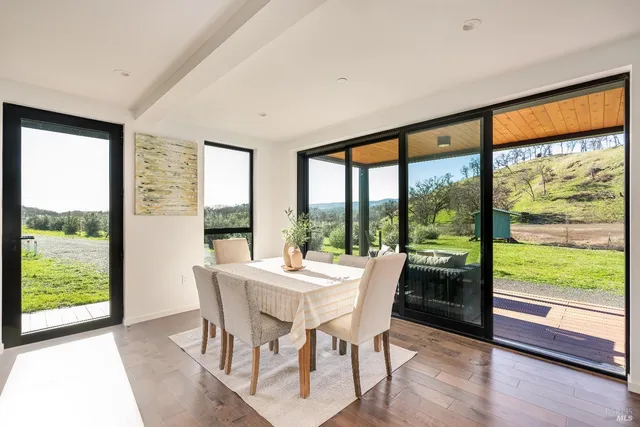 a living room with furniture fireplace and a large window