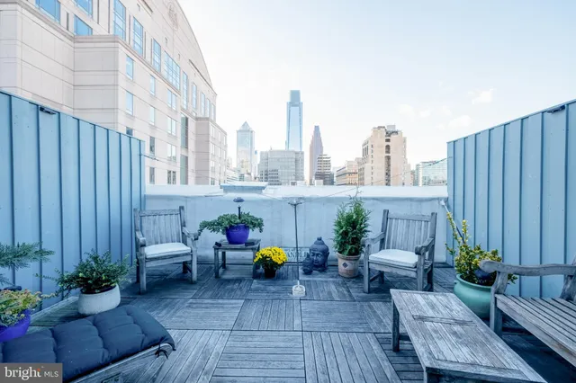 a view of a patio with couches chairs and potted plants