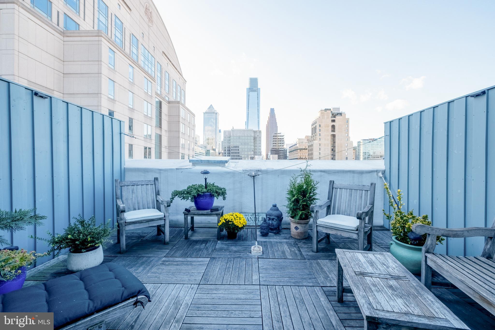 a view of a patio with couches chairs and potted plants