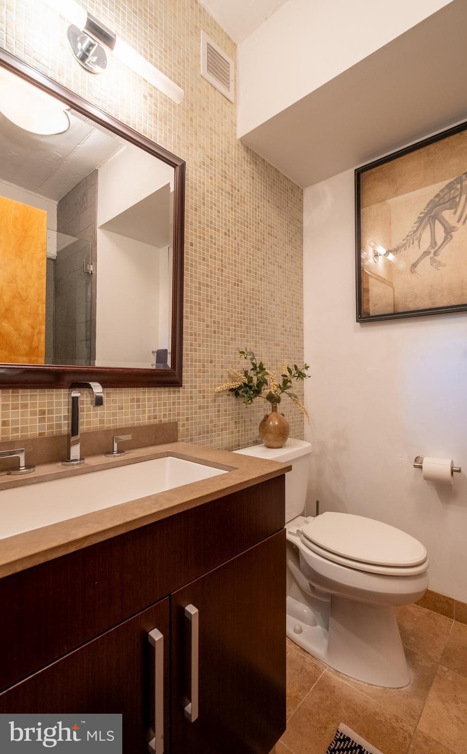 1228 Arch Street, Unit 8D Philadelphia, PA 19107 - Photo 12 of 26 a bathroom with a toilet sink and mirror