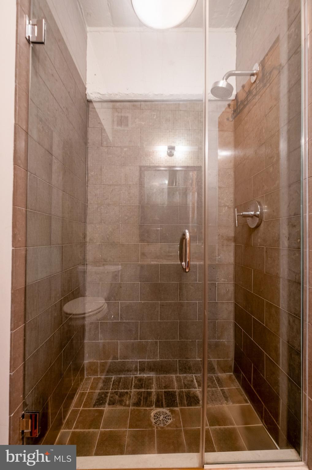 1228 Arch Street, Unit 8D Philadelphia, PA 19107 - Photo 13 of 26 a bathroom with a shower