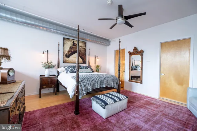 a bedroom with furniture and a rug