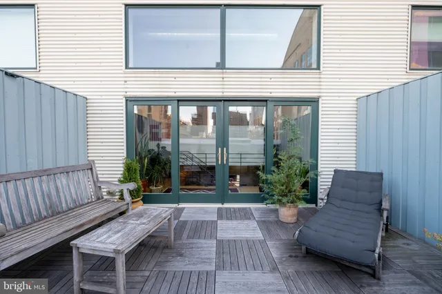 a view of outdoor living space with furniture and wooden floor