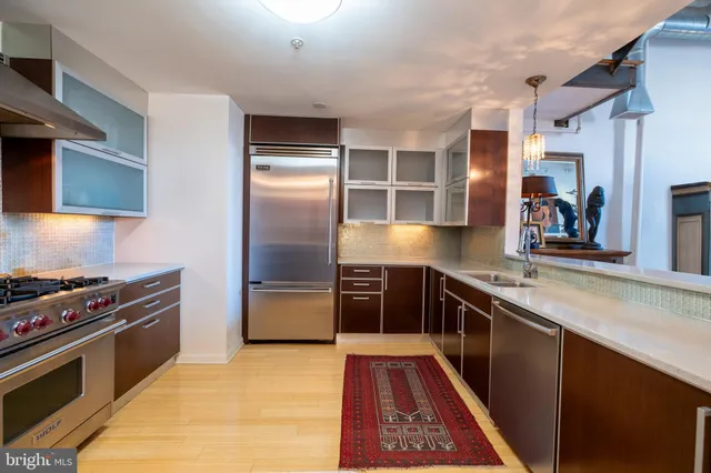 a kitchen with stainless steel appliances granite countertop a stove and a refrigerator