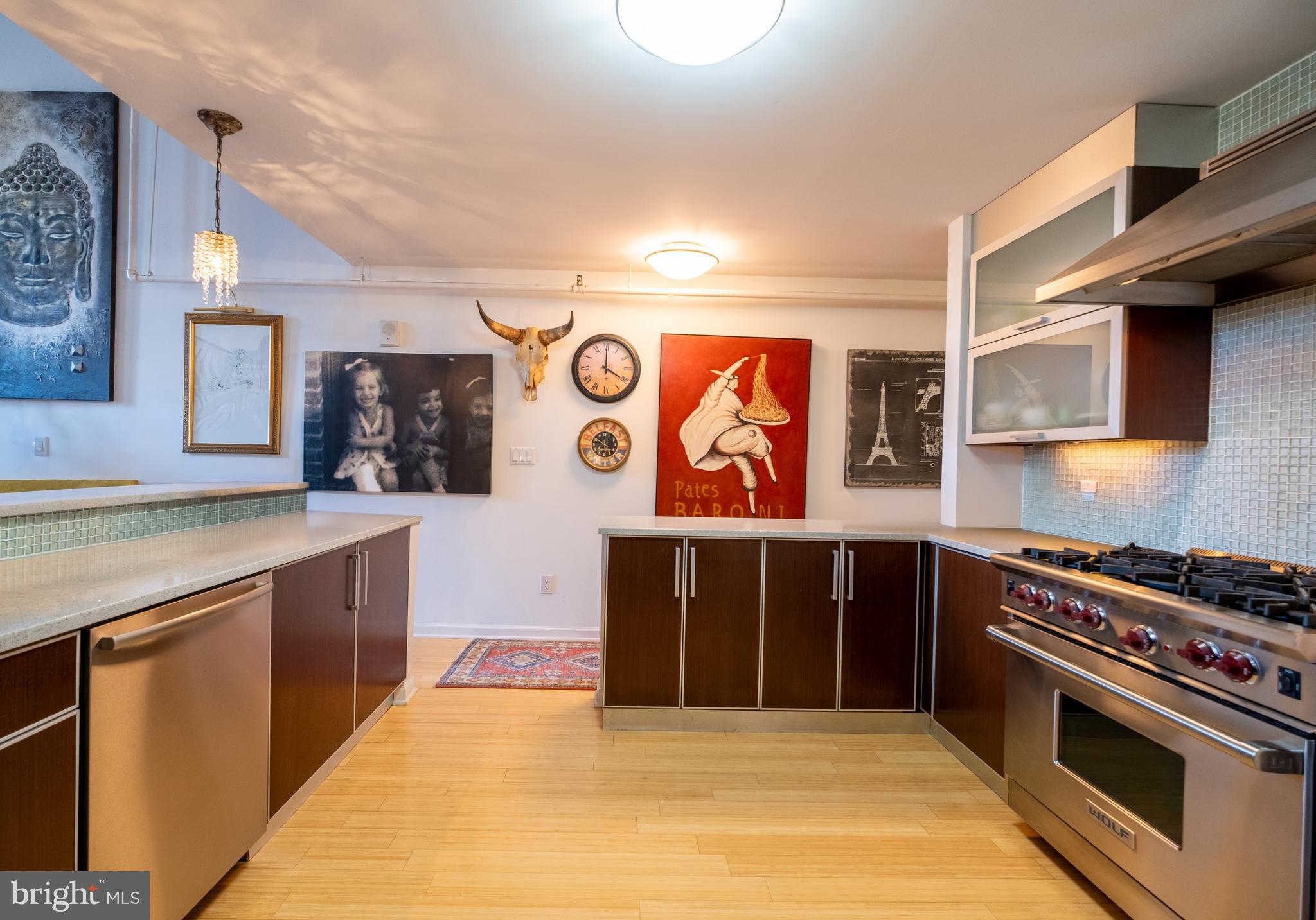 1228 Arch Street, Unit 8D Philadelphia, PA 19107 - Photo 7 of 26 a kitchen with stainless steel appliances granite countertop a stove a sink and a microwave
