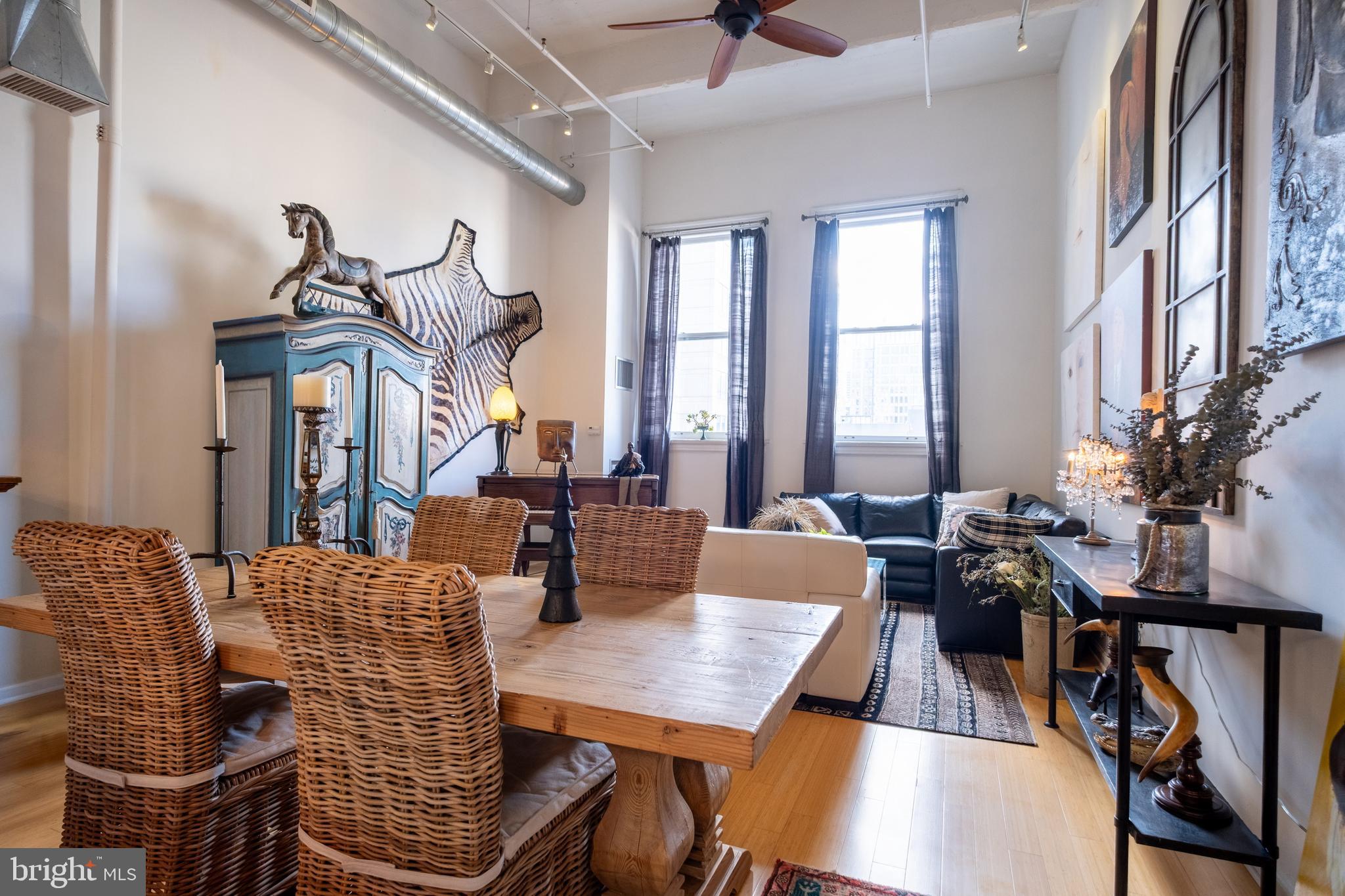 1228 Arch Street, Unit 8D Philadelphia, PA 19107 - Photo 8 of 26 a view of a dining room with furniture window and wooden floor