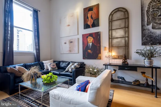 a living room with furniture flowerpot and a window