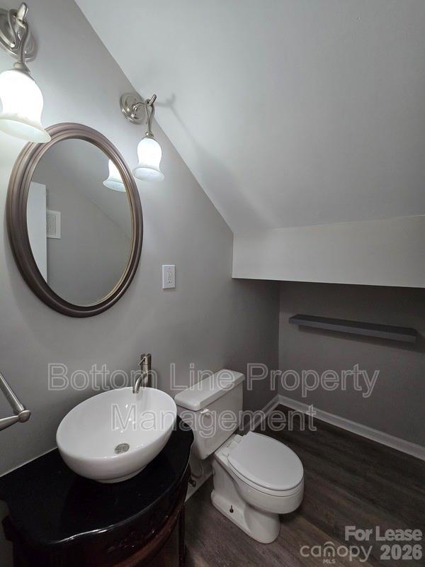 5949 Quail Hollow Road, Unit D Charlotte, NC 28210 - Photo 17 of 34 a bathroom with a toilet a sink and mirror