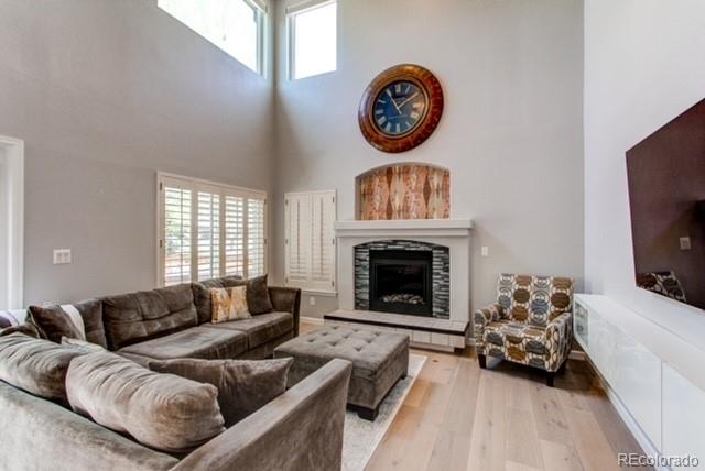 10144 Alexa Lane Highlands Ranch, CO 80130 - Photo 13 of 33 a living room with furniture and a fireplace