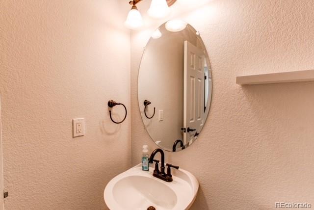 10144 Alexa Lane Highlands Ranch, CO 80130 - Photo 16 of 33 a bathroom with a sink and mirror