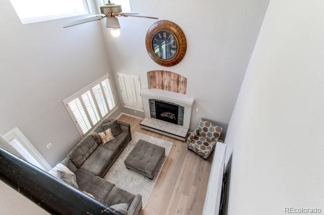 10144 Alexa Lane Highlands Ranch, CO 80130 - Photo 18 of 33 a living room with furniture a clock and a window