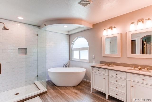 10144 Alexa Lane Highlands Ranch, CO 80130 - Photo 22 of 33 a spacious bathroom with a double vanity sink a mirror and a shower