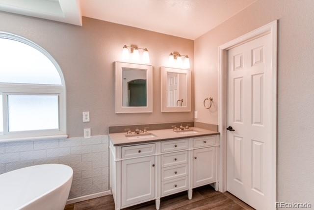 10144 Alexa Lane Highlands Ranch, CO 80130 - Photo 24 of 33 a bathroom with a granite countertop sink mirror and