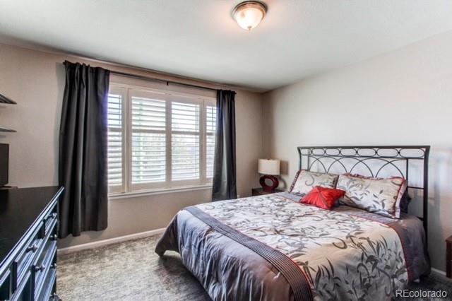 10144 Alexa Lane Highlands Ranch, CO 80130 - Photo 27 of 33 a bedroom with a bed and a window