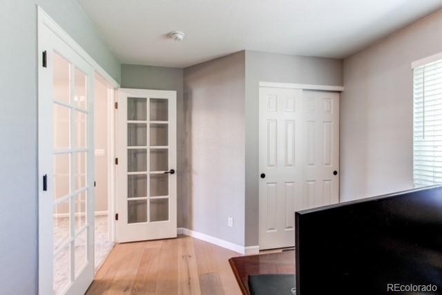 10144 Alexa Lane Highlands Ranch, CO 80130 - Photo 30 of 33 an empty room with wooden floor and windows