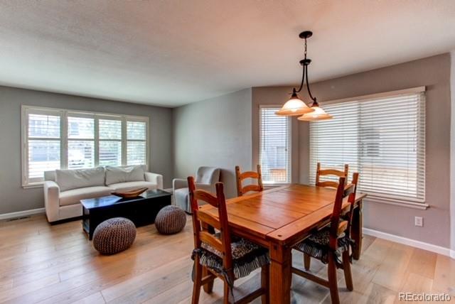10144 Alexa Lane Highlands Ranch, CO 80130 - Photo 3 of 33 a dining room with furniture and wooden floor