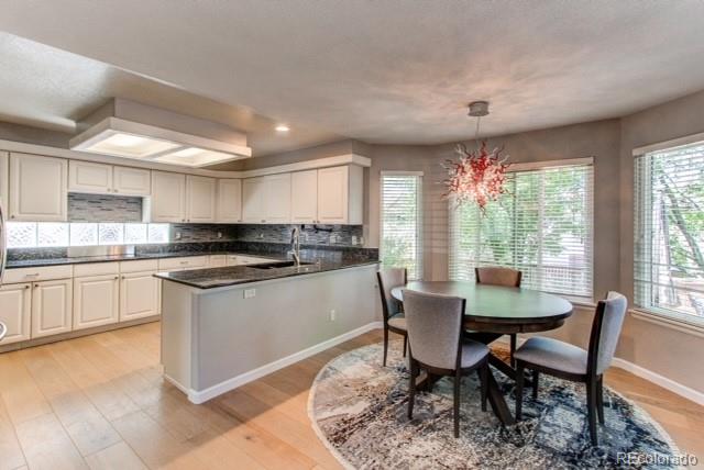 10144 Alexa Lane Highlands Ranch, CO 80130 - Photo 7 of 33 a kitchen with a dining table chairs and granite counter tops